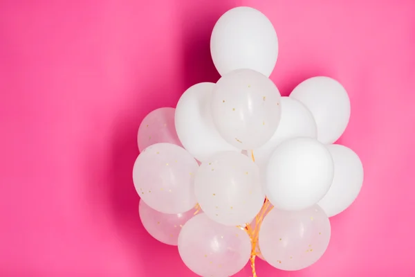 Close up of white helium balloons over pink — Stock Photo, Image