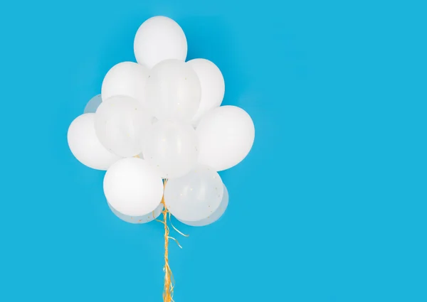 Close up of white helium balloons over blue — Stock Photo, Image