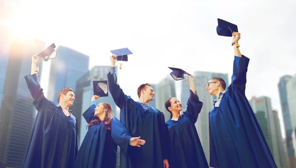 Group of smiling students with mortarboards — Stock Photo, Image