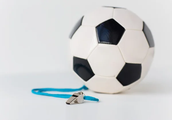 Close up of football or soccer ball and whistle — Stock Photo, Image