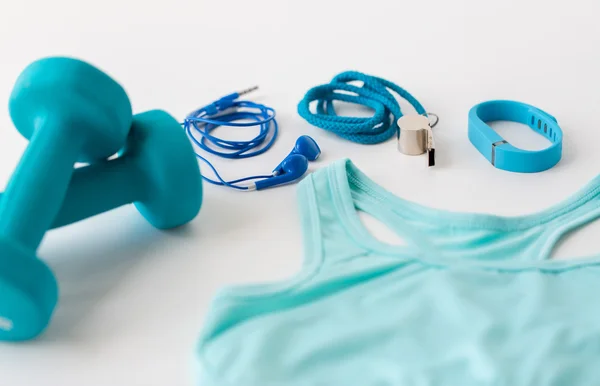 Close up of fitness tracker, earphones and whistle — Stock Photo, Image