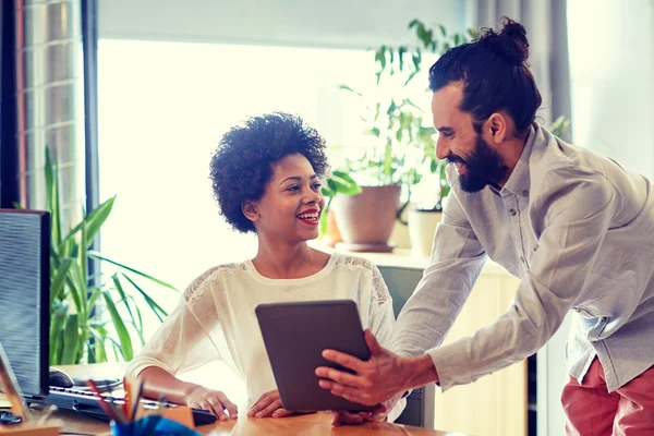 Happy creative team with tablet pc in office — Stock Photo, Image