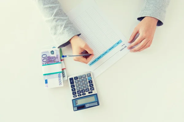 Close up of hands counting money with calculator — Stock Photo, Image