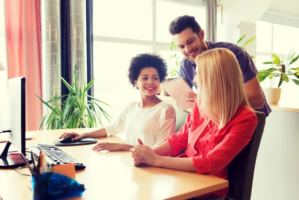 Gelukkig creatief team met computer op kantoor — Stockfoto