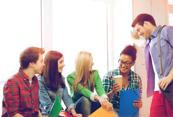 Students communicating and laughing at school — Stock Photo, Image