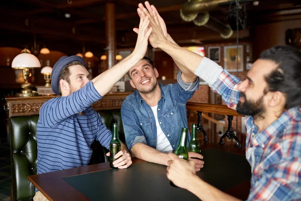 Men with beer making high five at bar or pub — Stock Photo, Image
