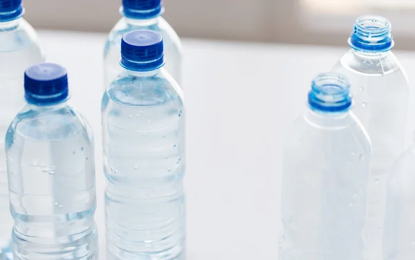 Close up of bottles with drinking water on table — Stock Photo, Image