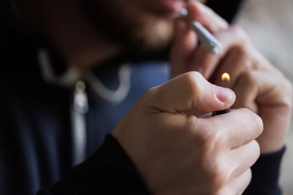 Close up of addict lighting up marijuana joint — Stock Photo, Image