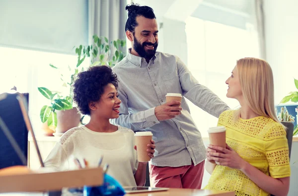 Lyckliga kreativa team dricka kaffe i office — Stockfoto
