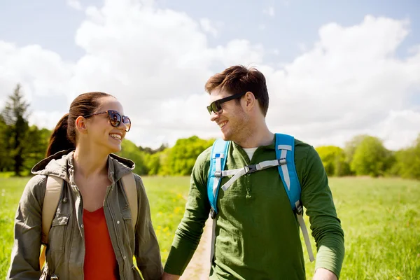 Happy couple with backpacks hiking outdoors — Stock Photo, Image