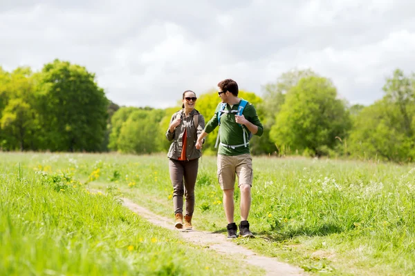 Gelukkige paar met rugzakken buiten wandelen — Stockfoto