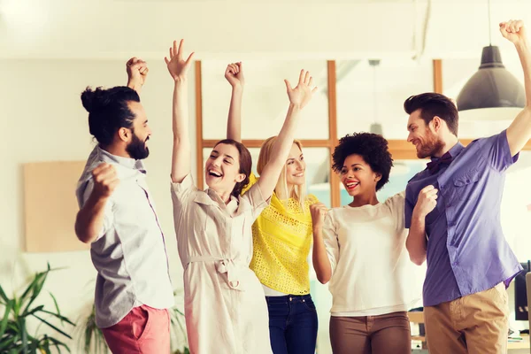 Feliz equipo creativo celebrando la victoria en el cargo — Foto de Stock