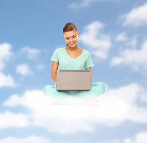 Felice giovane donna con computer portatile seduto su nuvola — Foto Stock