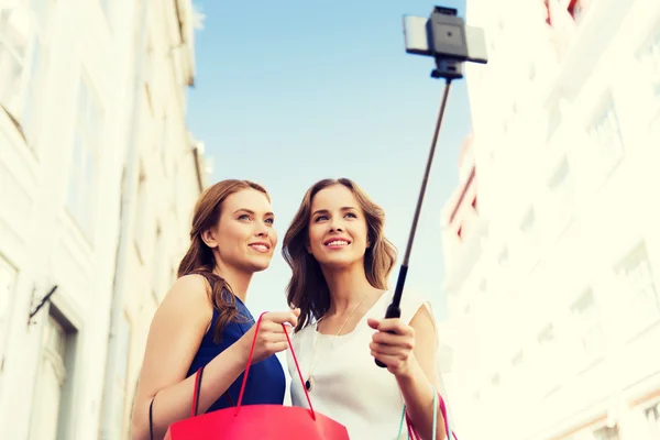 Женщины делают покупки и селфи на смартфоне — стоковое фото