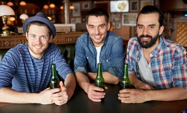 Šťastné kamarády pít pivo na bar či hospodu — Stock fotografie