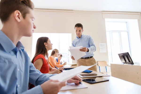 Group of students and teacher with test results — Stock Photo, Image