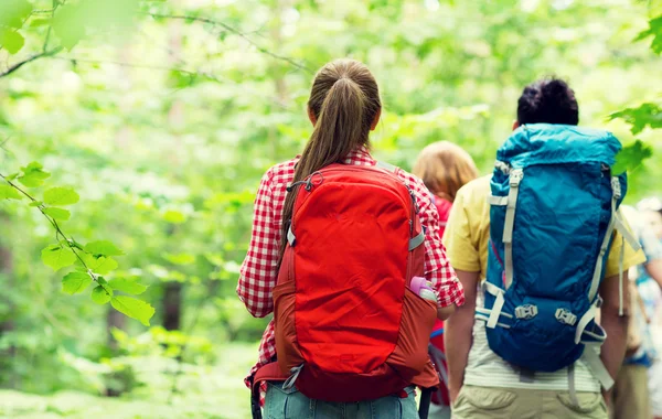 Close up of friends with backpacks hiking — Stock Photo, Image