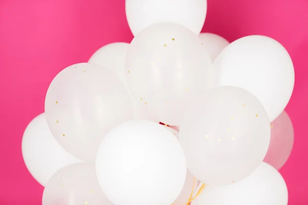Close up of white helium balloons over pink — Stock Photo, Image
