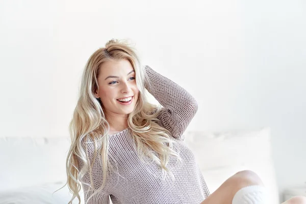 Happy young woman stretching in bed at home — Stock Photo, Image