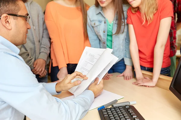 Group of students and teacher with tests at school — Stock Photo, Image