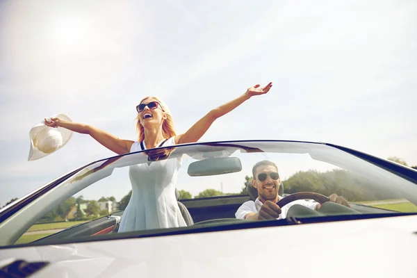 happy man and woman driving in cabriolet car