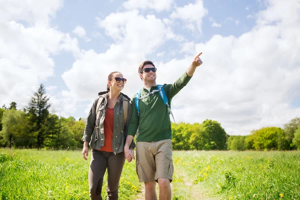 Happy couple with backpacks hiking outdoors — Stock Photo, Image