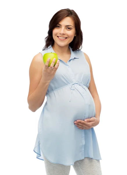 Happy pregnant woman holding green apple Stock Picture
