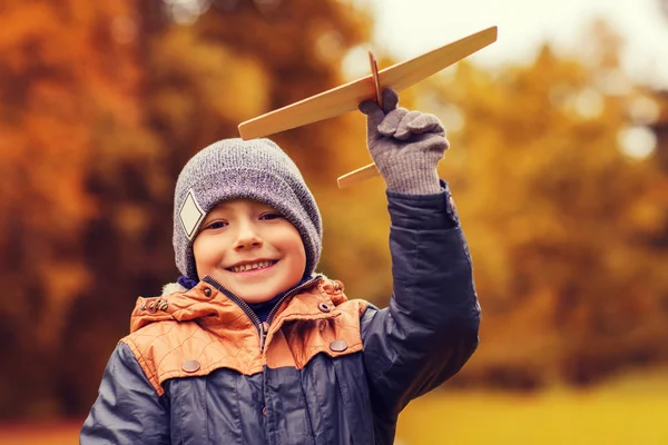 Happy little boy playing with toy plane outdoors — Stock Photo, Image