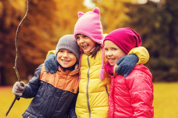 Gruppe fröhlicher Kinder umarmt sich im Herbstpark — Stockfoto