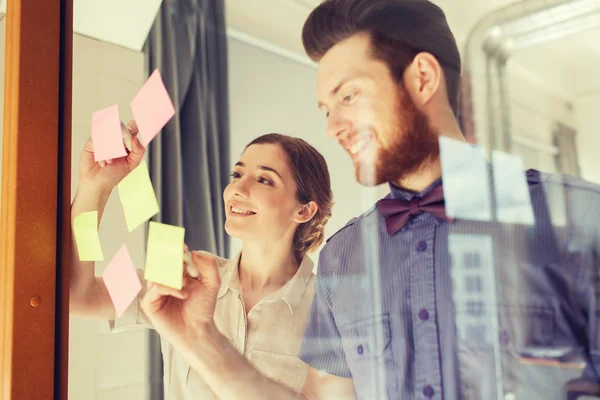 Glückliches Kreativ-Team schreibt auf Aufkleber im Büro — Stockfoto