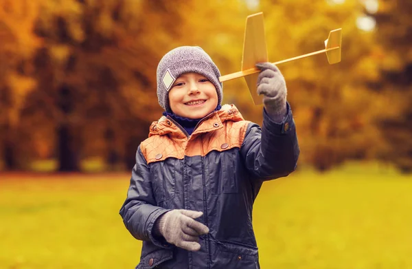 Happy little boy playing with toy plane outdoors — Stock Photo, Image