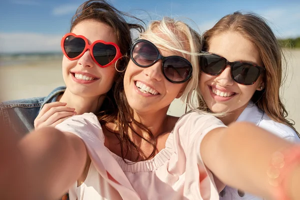 Grupo de mujeres sonrientes tomando selfie en la playa —  Fotos de Stock