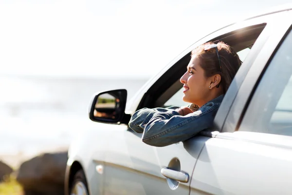 Glückliches Teenager-Mädchen oder junge Frau im Auto — Stockfoto