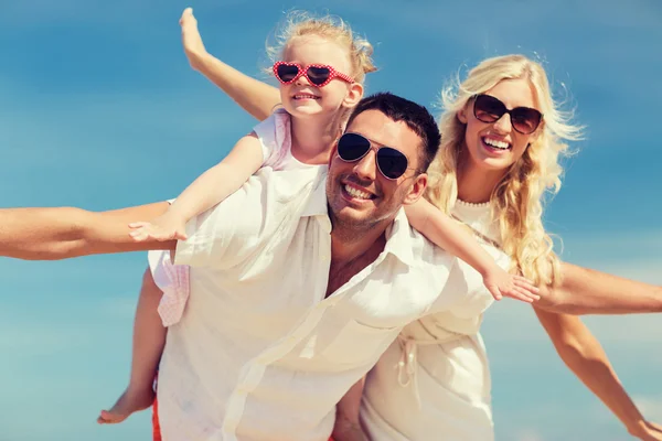 Happy family having fun over blue sky background — Stock fotografie