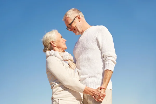 Happy senior couple holding hands outdoors — Stock Photo, Image