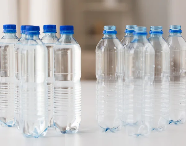 Close up of bottles with drinking water on table — Stock Photo, Image