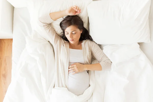 Mulher grávida feliz dormindo na cama em casa — Fotografia de Stock