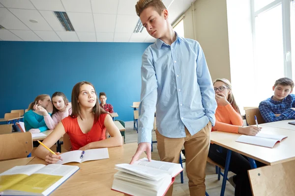 Étudiants bavardant derrière camarade de classe de retour à l'école — Photo