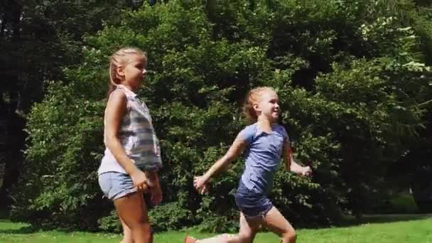 Happy kids running and playing tag game outdoors — Stock Video