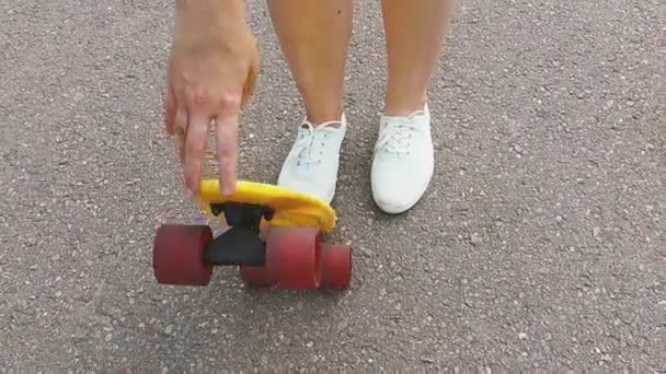 Adolescente colocando curto skate moderno para baixo — Vídeo de Stock