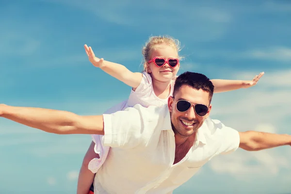 Happy family having fun over blue sky background — ストック写真