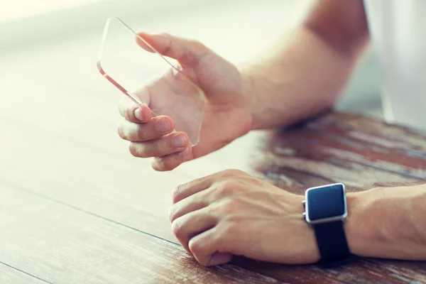 Close up of hands with smart phone and watch — Stock Photo, Image