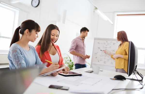 Glückliches Kreativteam mit Tablet-PC im Büro — Stockfoto