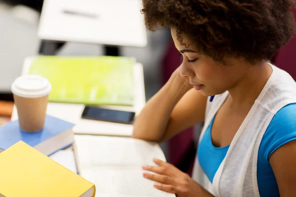 Student girl with books and coffee on lecture — Stock Photo, Image