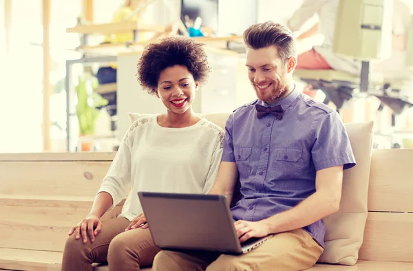 Happy creative team with laptop in office — Stock Photo, Image