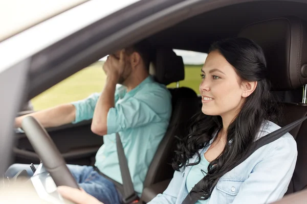 Woman driving car and man covering face with palm — Stock Photo, Image