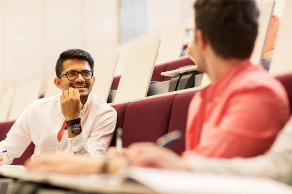 Grupo de estudiantes con cuadernos en la sala de conferencias — Foto de Stock