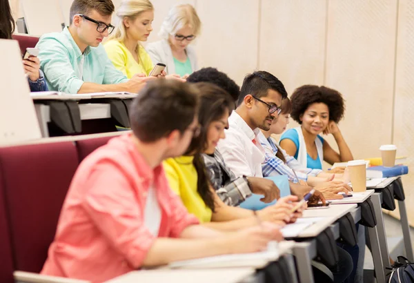 Group of students with coffee writing on lecture — Stock Photo, Image