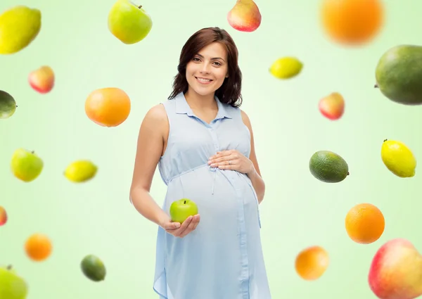 Szczęśliwa Kobieta w ciąży, gospodarstwa zielone jabłuszko Zdjęcia Stockowe bez tantiem