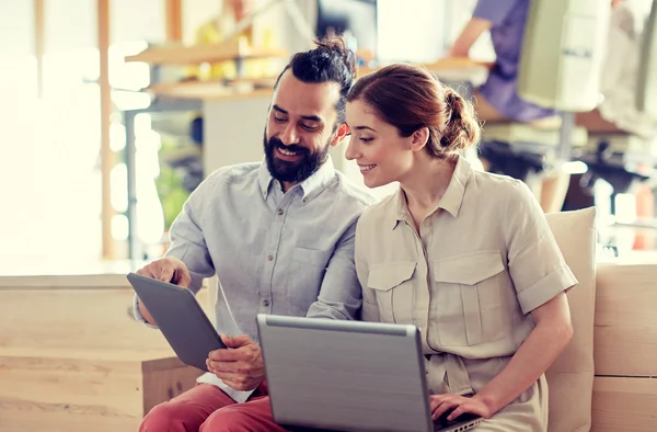 Creative team with tablet pc and laptop in office — Stock Photo, Image